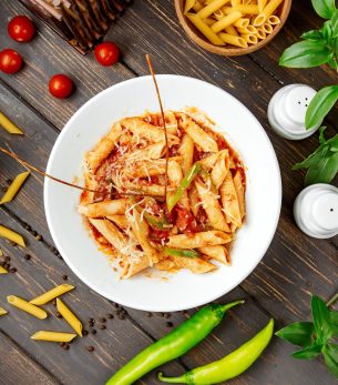 top view of penne pasta with tomato sauce and bell pepper